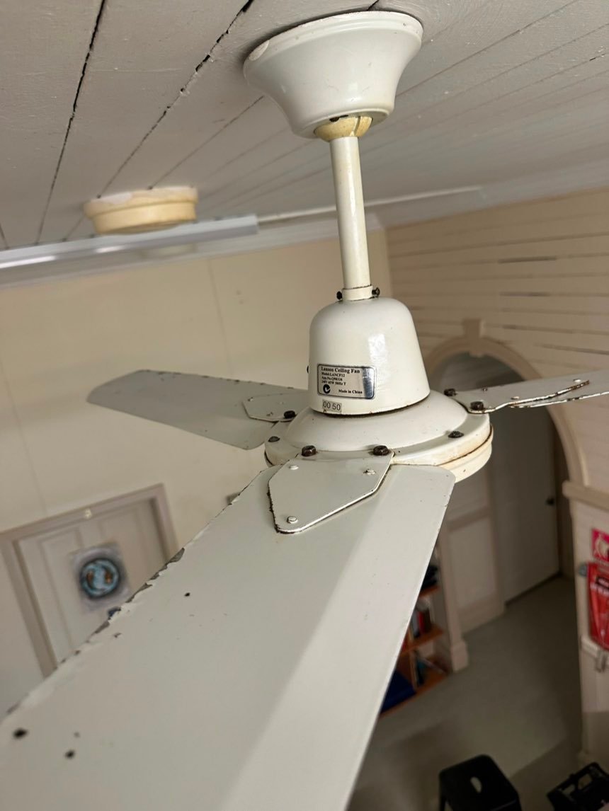 The same ceiling fan blades clean after remediation